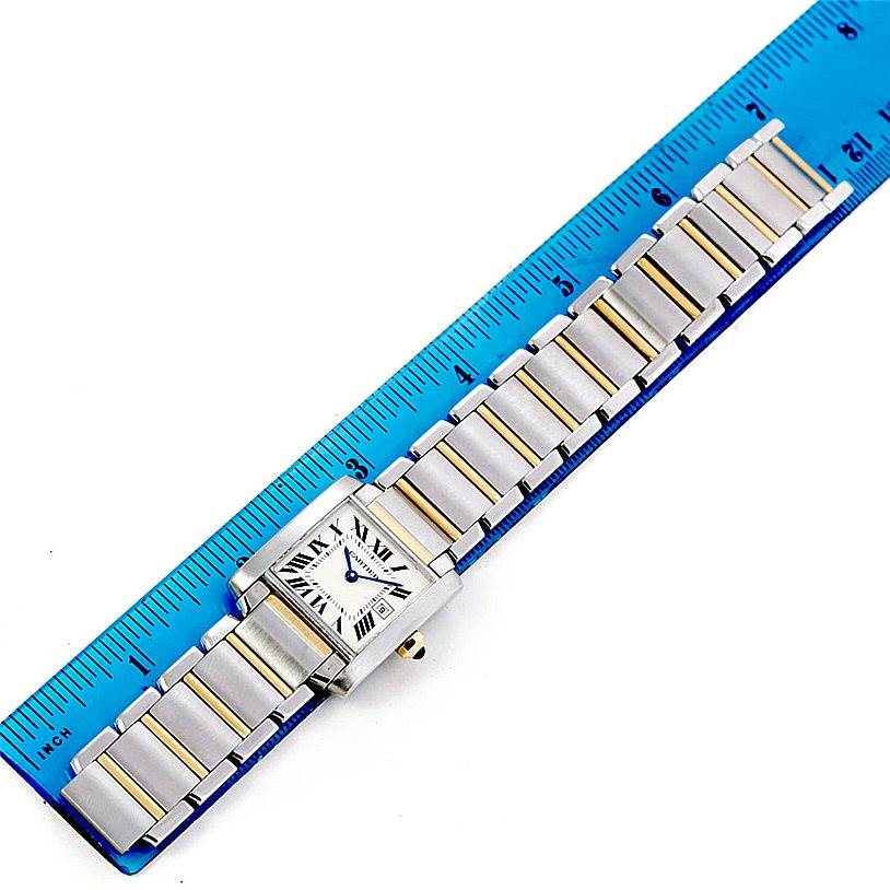 The Cartier Tank Francaise W51012Q4 Women's Steel and Gold (two tone) Silver Dial W51012Q4 Women's Steel and Gold (two tone) Silver Dial watch is shown from above, next to a ruler, highlighting its face and metal link bracelet.