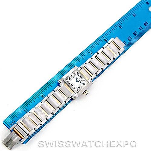 The image shows a Cartier Tank Francaise W51012Q4 Women's Steel and Gold (two tone) Silver Dial W51012Q4 Women's Steel and Gold (two tone) Silver Dial watch laid flat next to a blue ruler for scale comparison.