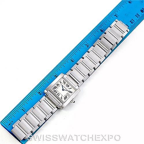 This image shows a Cartier Tank Française watch laid flat next to a ruler, featuring the watch face and full bracelet in view.