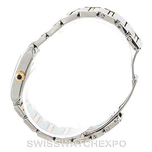 This image shows a side view of a Cartier Tank Francaise W51012Q4 Women's Steel and Gold (two tone) Silver Dial W51012Q4 Women's Steel and Gold (two tone) Silver Dial watch, highlighting its bracelet and the crown with a blue stone.