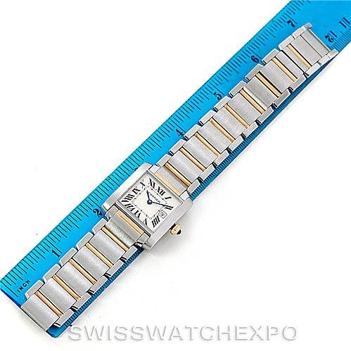 The image shows a Cartier Tank Francaise W51012Q4 Women's Steel and Gold (two tone) Silver Dial W51012Q4 Women's Steel and Gold (two tone) Silver Dial watch laid flat next to a blue ruler.