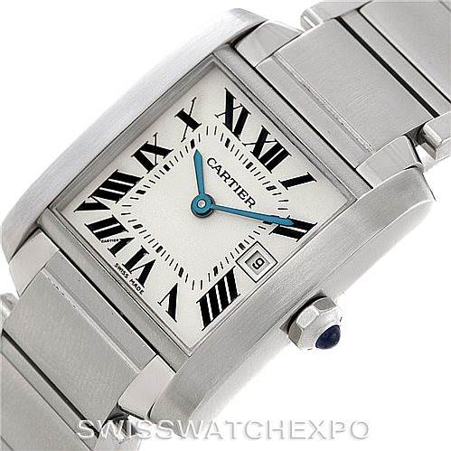 The image shows a close-up of a Cartier Tank Française watch, highlighting the face, Roman numerals, blue hands, and part of the bracelet.