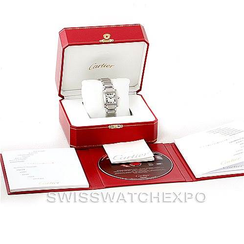 The Tank Francaise by Cartier is shown at an angle inside its box, accompanied by papers and a CD.