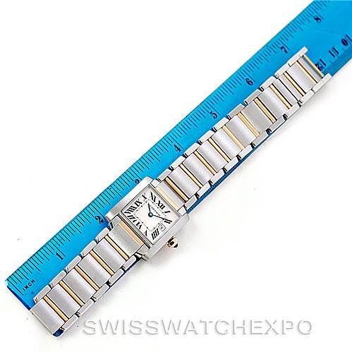 The image shows a top-down view of the Cartier Tank Française watch with its bracelet next to a blue ruler for scale.