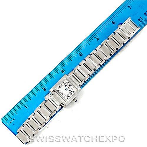 The image shows the Cartier Tank Française watch laid flat next to a blue ruler, highlighting its face and bracelet.