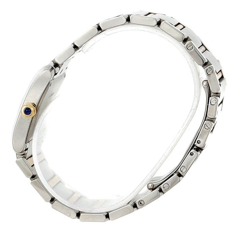 The image shows a side view of the Tank Francaise model by Cartier, highlighting its metal bracelet and crown with a blue gem.