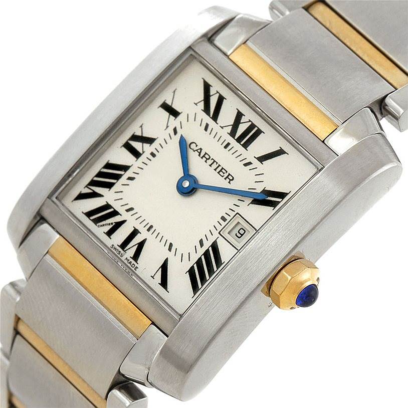 The image shows a close-up of the Cartier Tank Francaise W51012Q4 Women's Steel and Gold (two tone) Silver Dial W51012Q4 Women's Steel and Gold (two tone) Silver Dial watch face, bracelet, and crown with the gemstone.