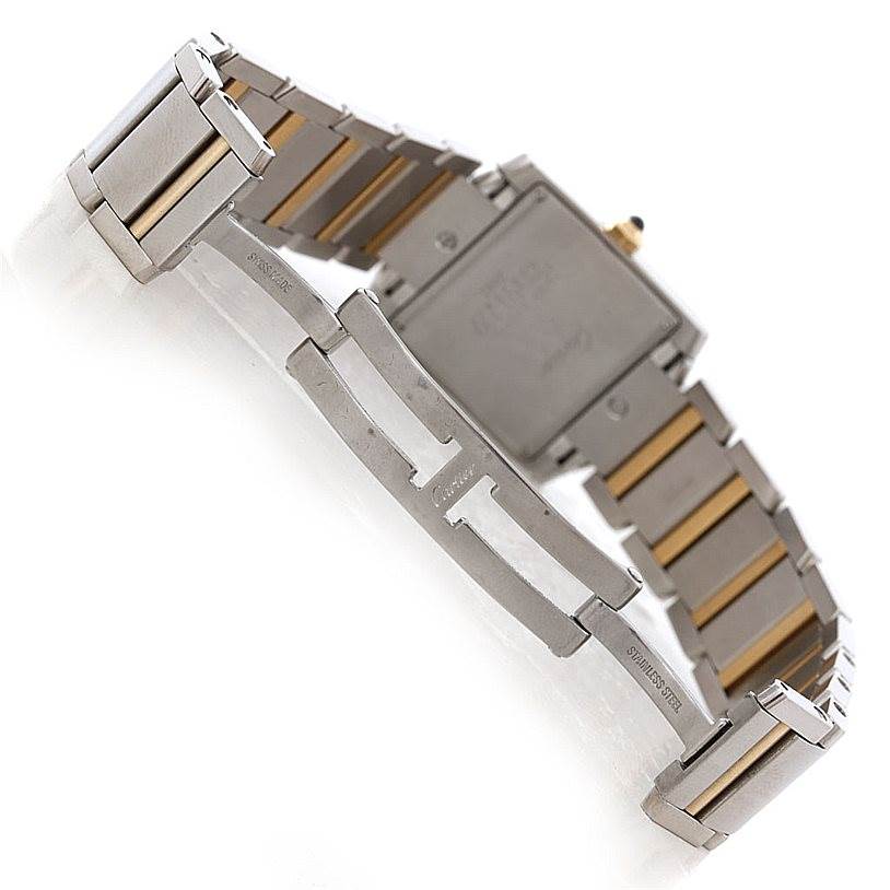The image shows the backside and clasp mechanism of the Cartier Tank Française watch, highlighting its metal bracelet.