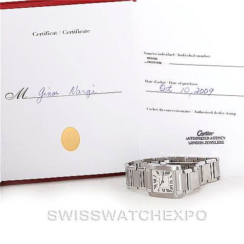 The image shows a Tank Française watch by Cartier along with its certification papers from an overhead angle.