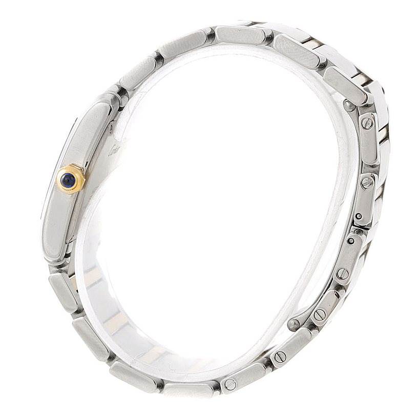 The image shows a side view of the Tank Française watch by Cartier, highlighting its metal bracelet and crown with a blue cabochon.