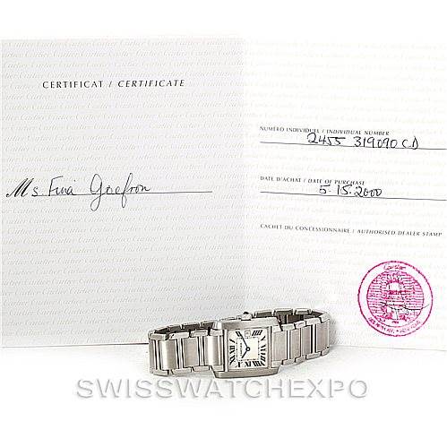 This image shows a Cartier Tank Française watch positioned in front of its certificate and documentation.