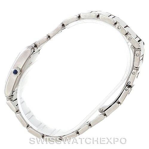 The Cartier Tank Française watch is shown from a side angle, highlighting the bracelet and case.