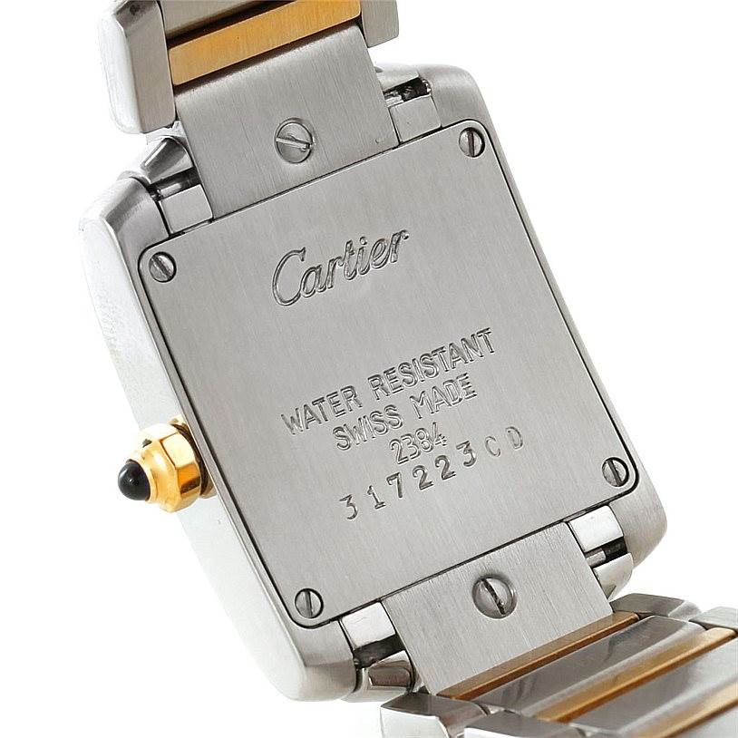 The image shows the back case and part of the bracelet of the Cartier Tank Française watch with visible inscriptions.