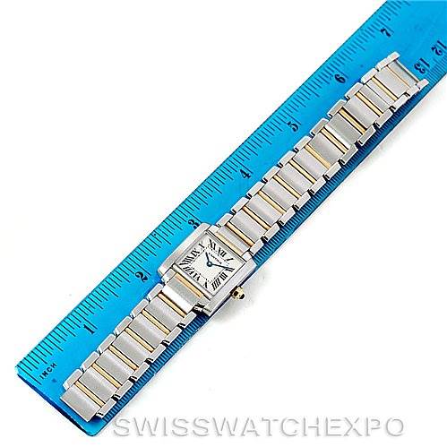 The image shows a Cartier Tank Française watch laid flat next to a ruler, highlighting its band and rectangular face from a top-down view.