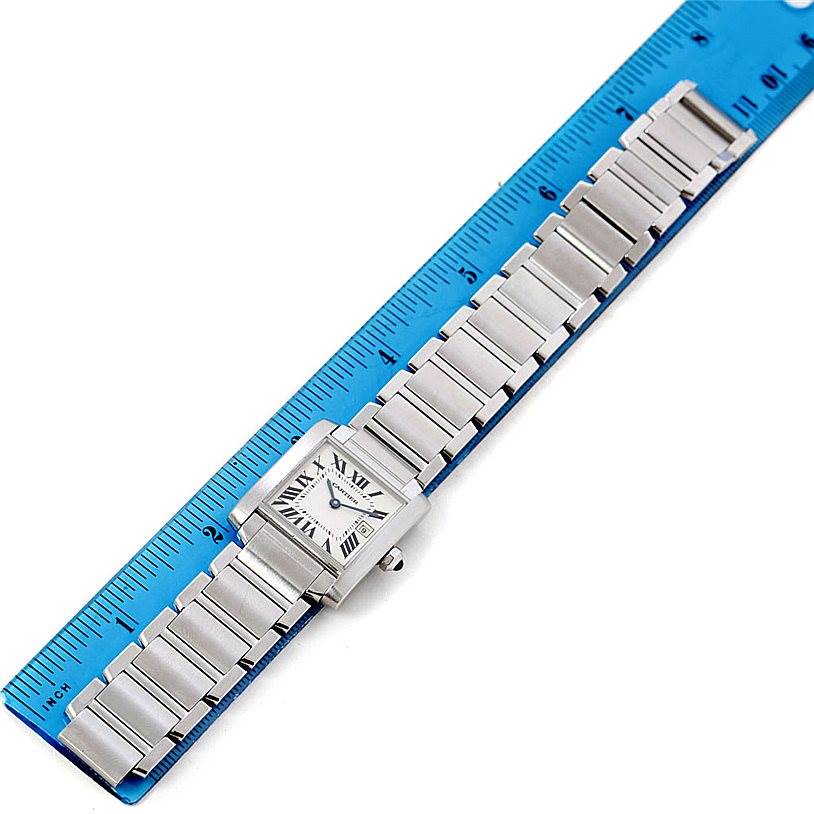 This image shows a Cartier Tank Francaise W51011Q3 Women's Stainless Steel Silver Dial W51011Q3 Women's Stainless Steel Silver Dial watch laid flat, aligned with a ruler for measurement.
