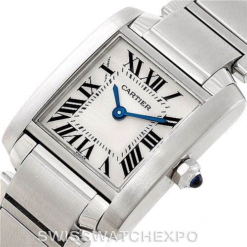 The image shows a close-up of a Cartier Tank Francaise W51008Q3 Women's Stainless Steel Silver Dial W51008Q3 Women's Stainless Steel Silver Dial watch face and part of its bracelet, highlighting the Roman numerals and blue hands.