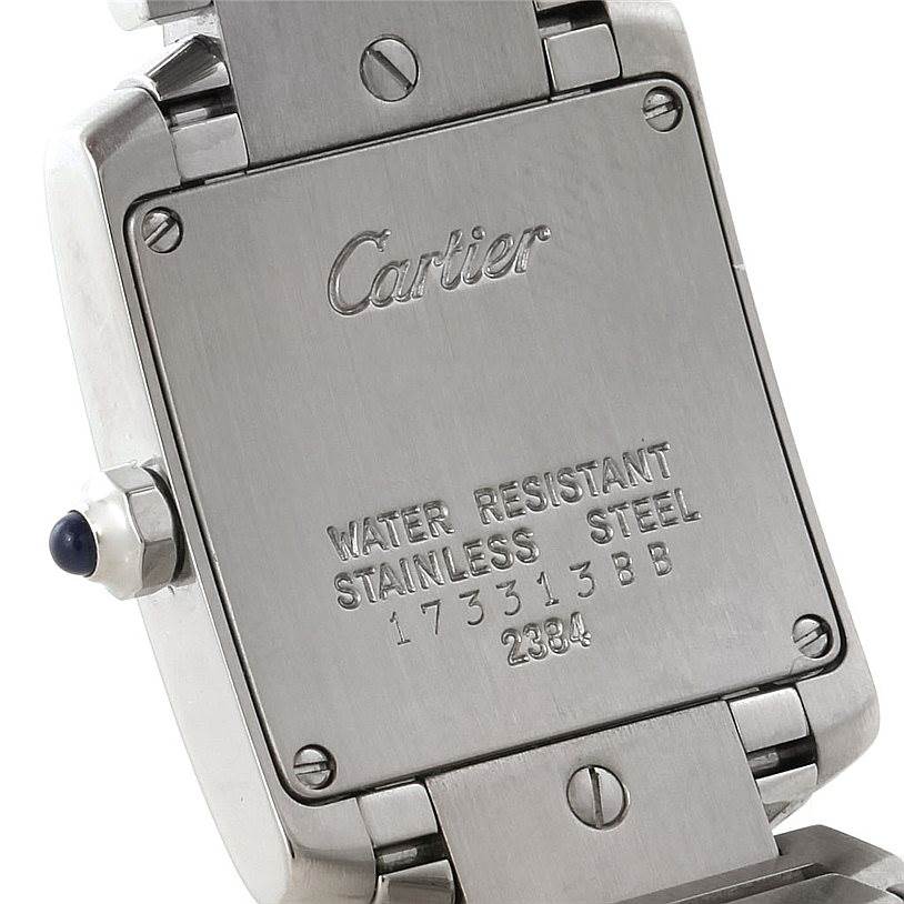 The image shows the back case and part of the bracelet of a Cartier Tank Française watch, highlighting the brand name and model details.