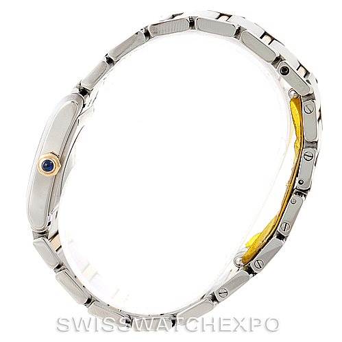 This image shows a side profile of the Cartier Tank Française watch, highlighting its metal bracelet and crown with a blue cabochon.