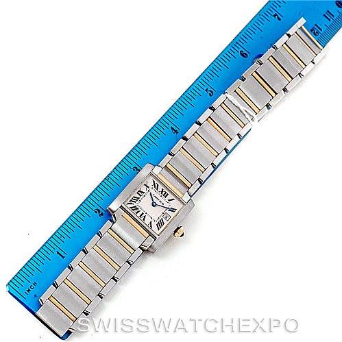 The Cartier Tank Francaise W51012Q4 Women's Steel and Gold (two tone) Silver Dial W51012Q4 Women's Steel and Gold (two tone) Silver Dial watch is shown from a top view, displaying its entire face, bracelet, and a portion of a ruler for scale.