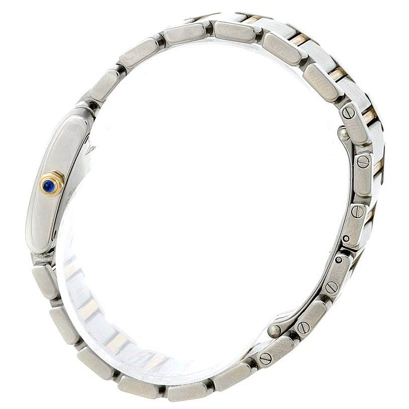 The Tank Francaise by Cartier is shown from a side angle, displaying its metal bracelet and crown with a blue cabochon.