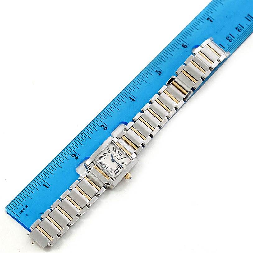 This photo shows a top-down view of a Cartier Tank Francaise W51007Q4 Women's Steel and Gold (two tone) Silver Dial W51007Q4 Women's Steel and Gold (two tone) Silver Dial watch with a blue ruler for scale.