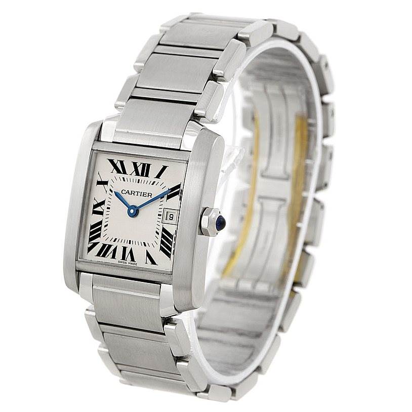 The image shows a Cartier Tank Française watch viewed from a slight angle, highlighting the face, crown, and stainless steel bracelet.