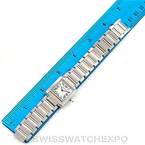 The image shows a top-down view of a Cartier Tank Française watch, including its rectangular face and stainless steel bracelet, alongside a ruler.