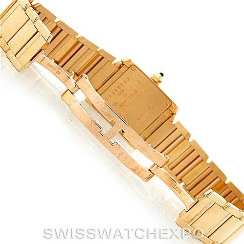 This image shows a close-up view of the gold-toned bracelet and clasp of a Cartier Tank Française watch.