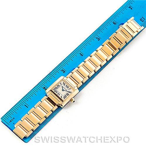 The Cartier Tank Française watch is shown fully extended alongside a ruler for measurement.
