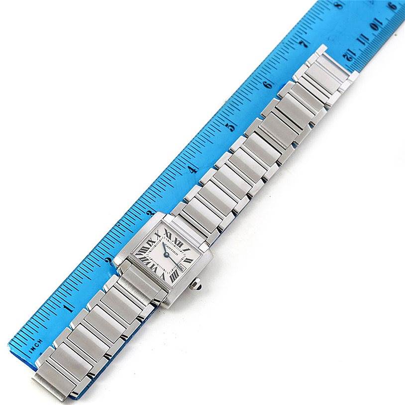 The Cartier Tank Francaise W51011Q3 Women's Stainless Steel Silver Dial W51011Q3 Women's Stainless Steel Silver Dial watch is shown from a top-down angle, highlighting its bracelet and face, with a ruler for scale.