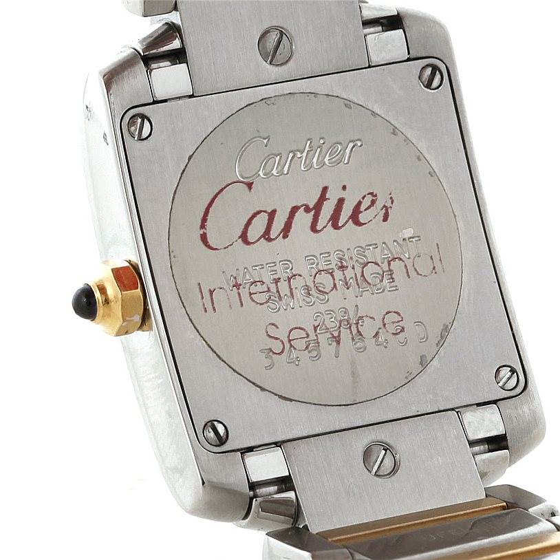 The image shows the back case of a Cartier Tank Francaise W51007Q4 Women's Steel and Gold (two tone) Silver Dial W51007Q4 Women's Steel and Gold (two tone) Silver Dial watch, highlighting its engravings and clasp mechanism.