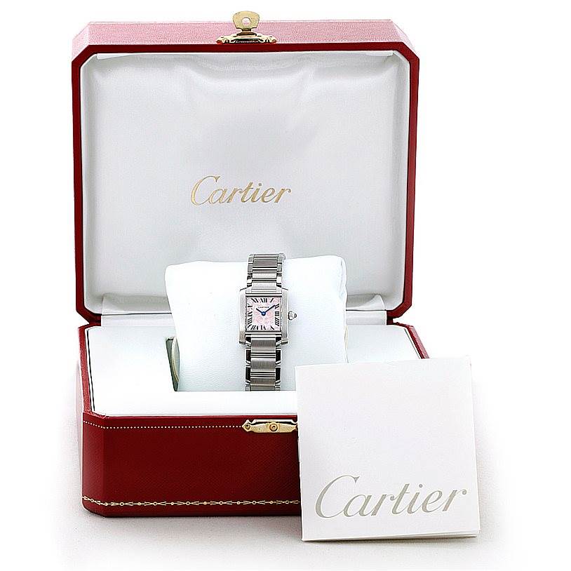 The Tank Francaise by Cartier is displayed in an open box, showing the watch face, band, and Cartier booklet.