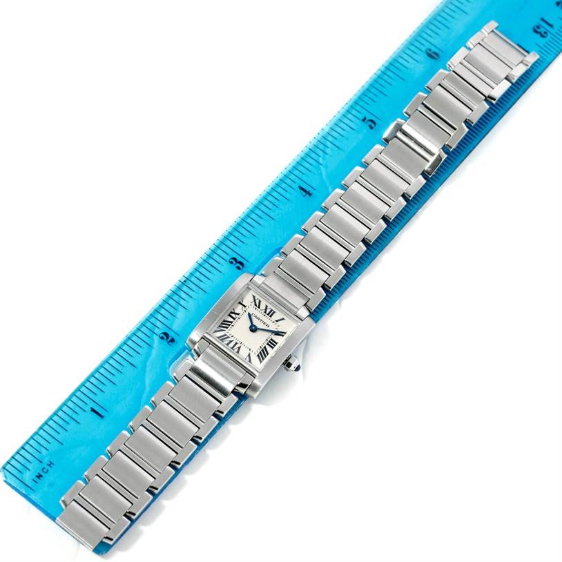 The Cartier Tank Francaise W51008Q3 Women's Stainless Steel Silver Dial W51008Q3 Women's Stainless Steel Silver Dial watch is shown from a top-down angle next to a ruler.