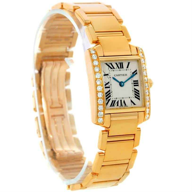 The Cartier Tank Francaise WE1001R8 Women's Yellow Gold Silver Dial WE1001R8 Women's Yellow Gold Silver Dial watch is shown at an angle, highlighting the gold bracelet, diamond-set bezel, and Roman numeral dial.
