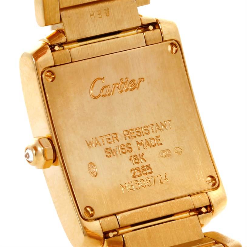 This image shows the back case of a Cartier Tank Française watch, highlighting its engravings and bracelet attachment.