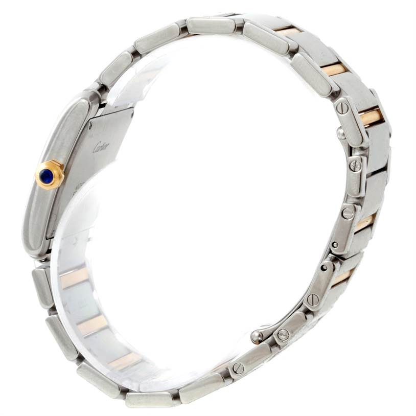 This image shows a side view of a Cartier Tank Francaise W51012Q4 Women's Steel and Gold (two tone) Silver Dial W51012Q4 Women's Steel and Gold (two tone) Silver Dial watch, highlighting the bracelet and case with a blue cabochon on the crown.