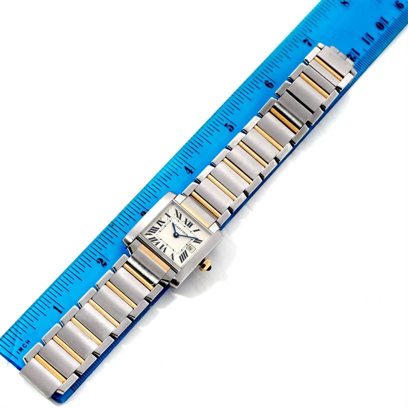 The Cartier Tank Francaise W51012Q4 Women's Steel and Gold (two tone) Silver Dial W51012Q4 Women's Steel and Gold (two tone) Silver Dial watch is shown from above, placed next to a ruler for scale.