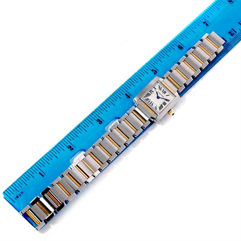 The image shows a Cartier Tank Francaise W51007Q4 Women's Steel and Gold (two tone) Silver Dial W51007Q4 Women's Steel and Gold (two tone) Silver Dial watch laid flat next to a ruler, displaying the entire strap and watch face.