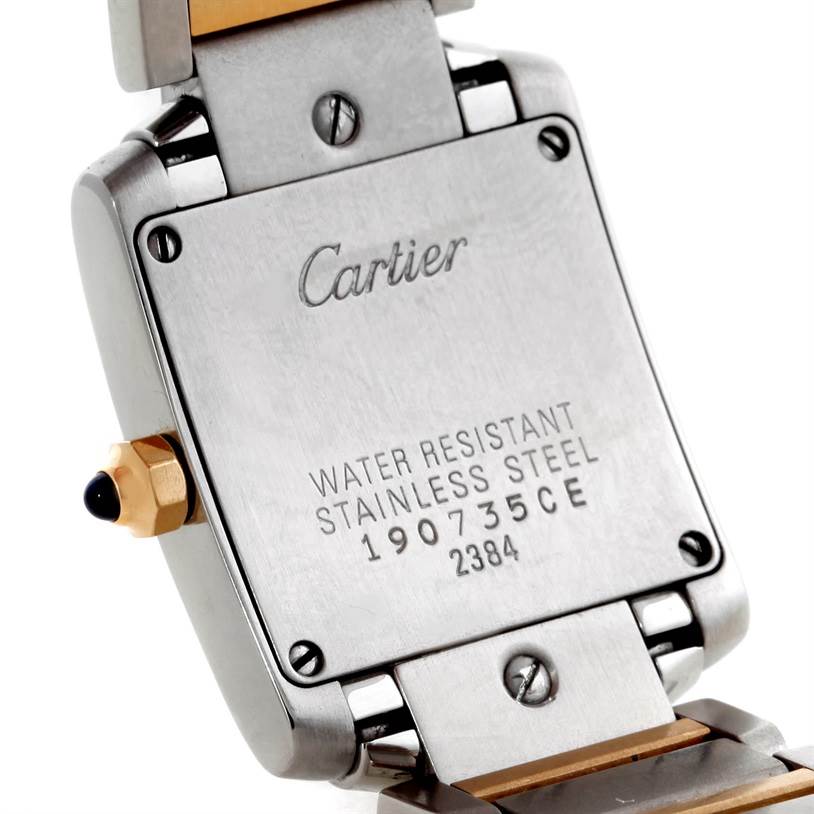 The image shows the back case and part of the bracelet of a Cartier Tank Française watch from a close-up angle.