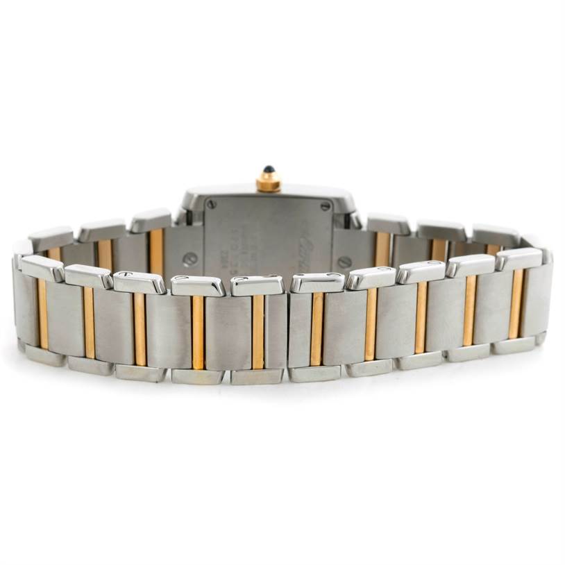 The image shows the back of a Cartier Tank Française watch, highlighting its two-tone metal bracelet from a rear view.