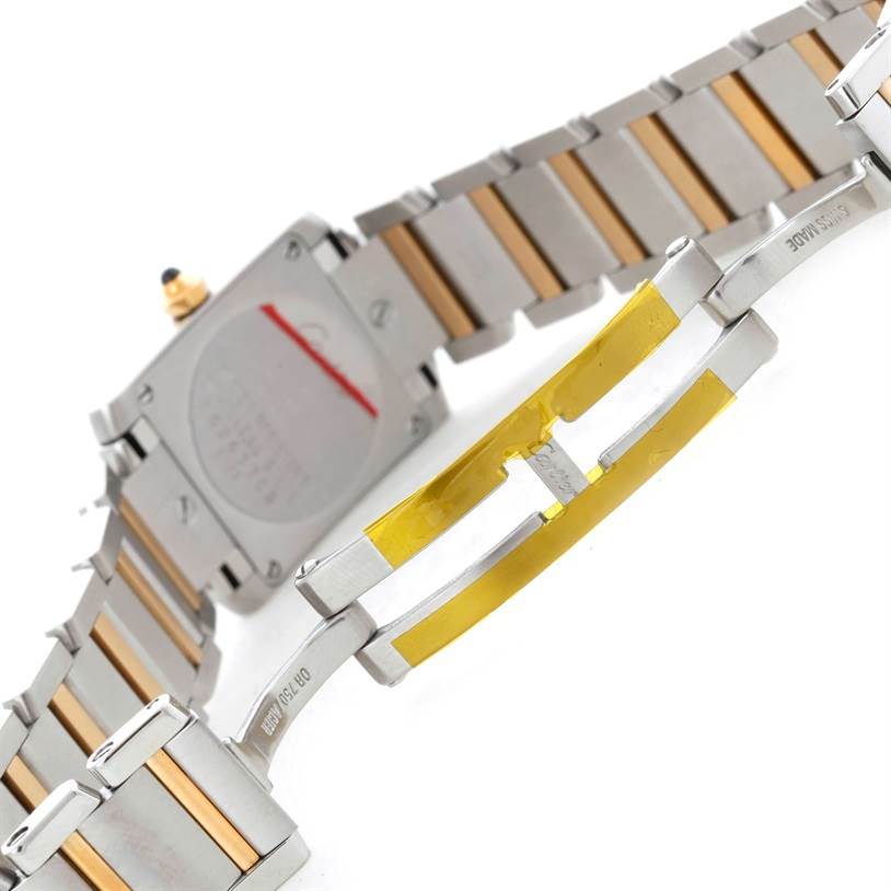 The image shows the back case and two-tone bracelet of the Cartier Tank Française watch at a tilted angle.