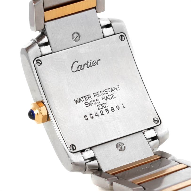 The image shows the back case and part of the bracelet of a Cartier Tank Francaise W51006Q4 Women's Steel and Gold (two tone) Silver Dial W51006Q4 Women's Steel and Gold (two tone) Silver Dial watch at an angled view.
