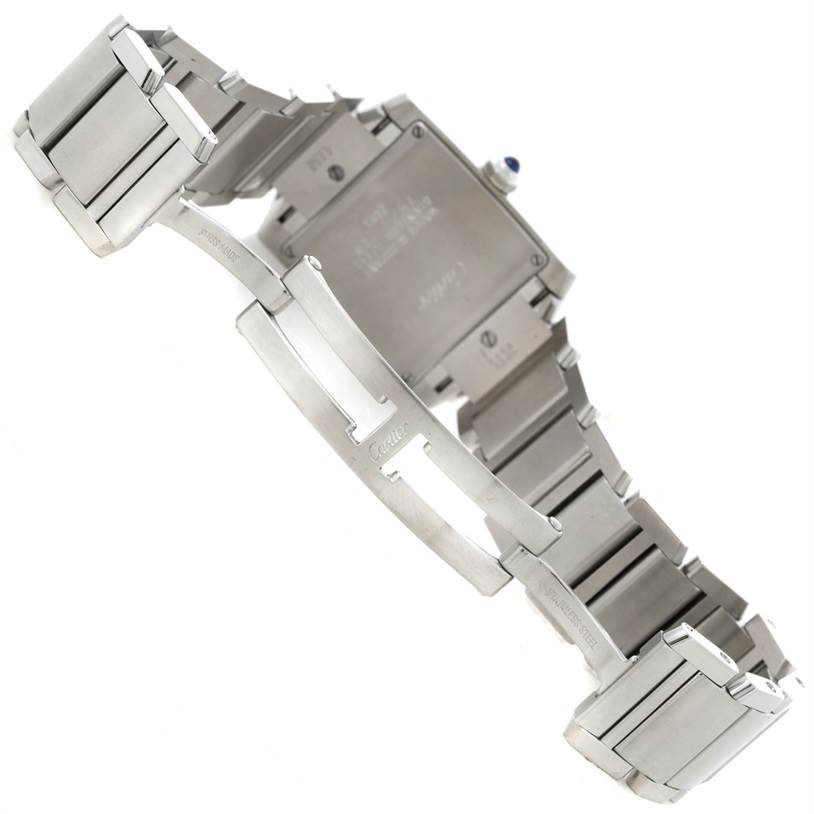 The image shows the back and bracelet of a Cartier Tank Française watch at an angle.