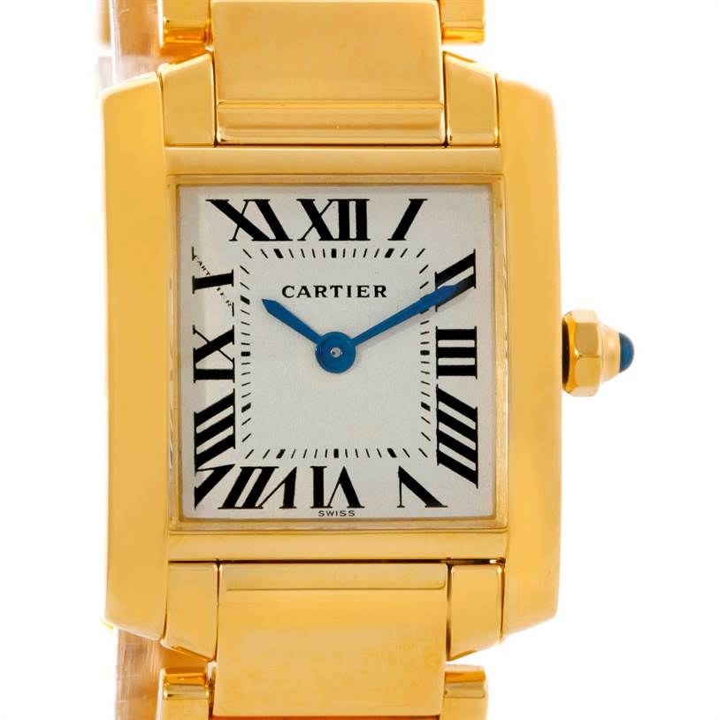 The image shows the face and part of the bracelet of a Cartier Tank Française watch, highlighting its gold case, blue hands, and Roman numerals.
