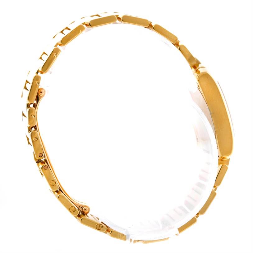 This image shows a side profile of the gold bracelet and case of a Tank Française watch by Cartier.