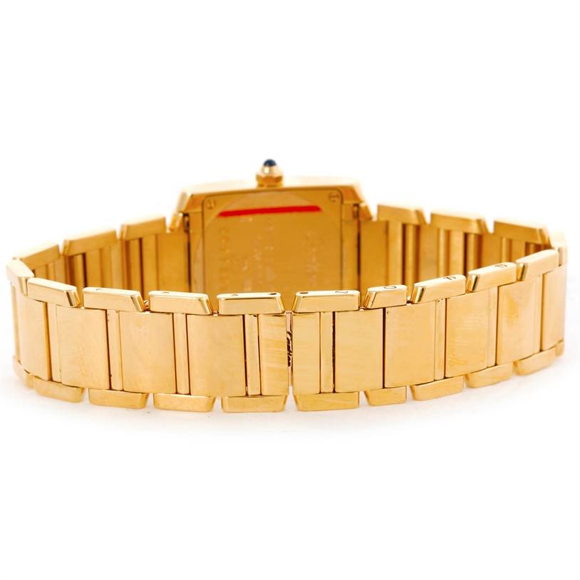 The image shows the back view of the Cartier Tank Francaise W50002N2 Women's Yellow Gold Silver Dial W50002N2 Women's Yellow Gold Silver Dial watch, highlighting its gold bracelet and case back.