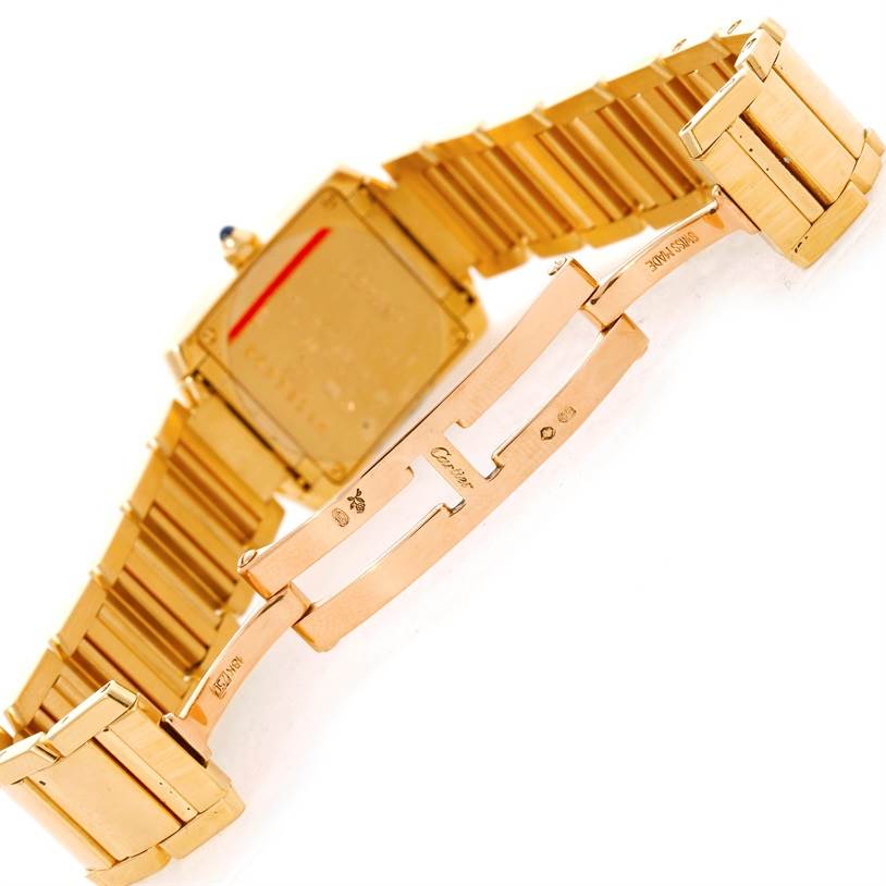 This image shows the backside and clasp mechanism of a Cartier Tank Francaise W50002N2 Women's Yellow Gold Silver Dial W50002N2 Women's Yellow Gold Silver Dial watch, featuring a gold metal bracelet.