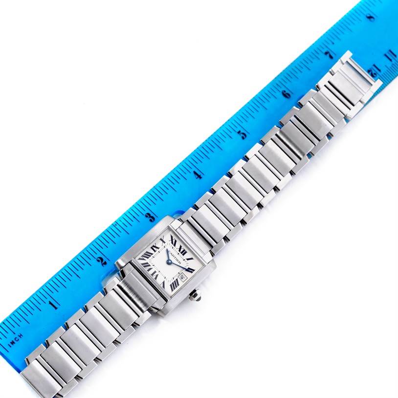 The Cartier Tank Francaise W51011Q3 Women's Stainless Steel Silver Dial W51011Q3 Women's Stainless Steel Silver Dial watch is shown from the top, with both the watch face and bracelet visible alongside a blue ruler.