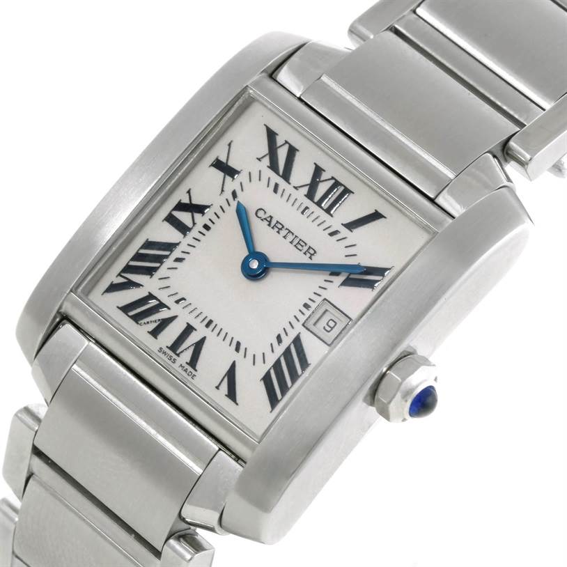 The image shows a close-up angle of a Cartier Tank Française watch, highlighting its face, bracelet, and crown with a blue cabochon.