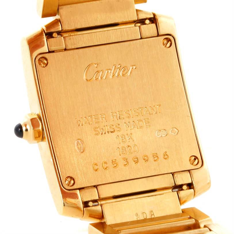 The image shows the back case and part of the band of a Cartier Tank Française watch.